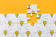 Free Above View Arrangement With Puzzle On Orange Background Psd