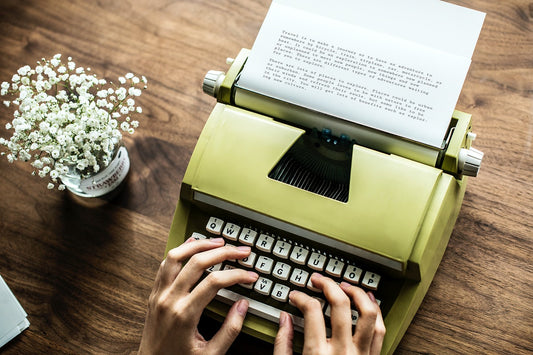 Free Aerial View A Woman Using A Retro Typewriter