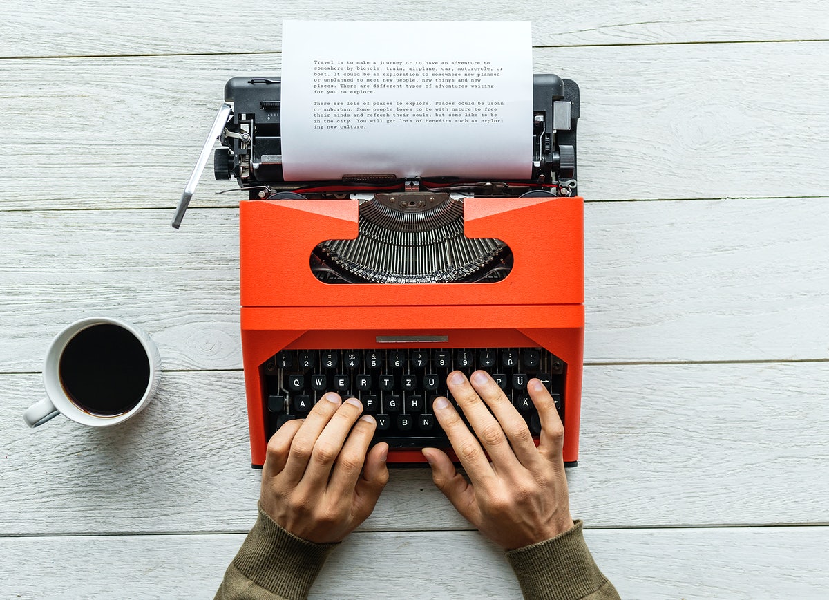 Free Aerial View Of A Man Typing On A Retro Typewriter