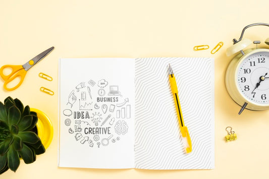 Free Agenda On Workspace With Plant And Clock Psd