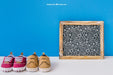Free Baby Mockup With Slate And Two Pairs Of Shoes Psd
