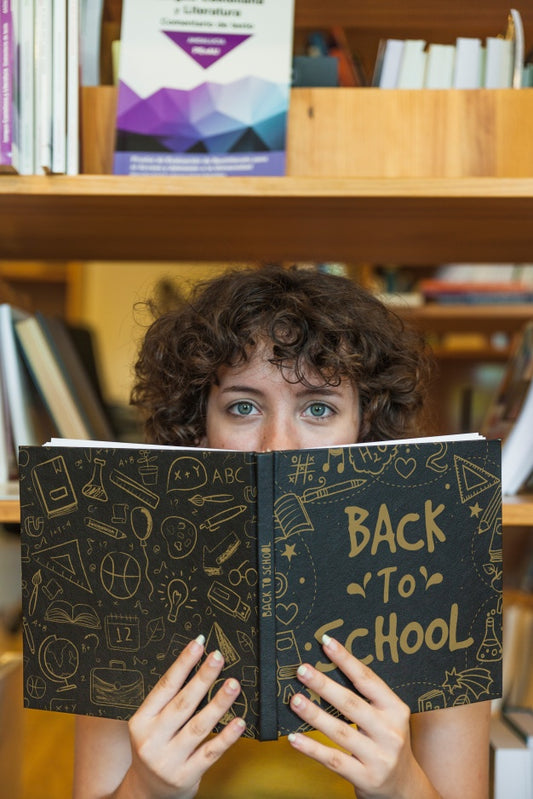 Free Back To School Concept With Girl Reading Book In Library Psd