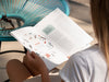 Free Back View Blonde Woman Looking Into A Nature Book Psd