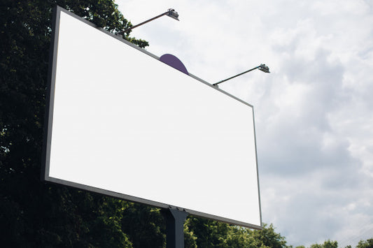 Free Bilbard With Multi-Colored Advertising And Illumination Stands On The Street In Daylight, Photo Below Psd
