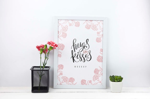 Free Carnation Flowers In Pencil Holder Next To Frame Mockup Psd