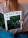 Free Close-Up Casual Dressed Woman Holding A Mock Up Magazine Psd