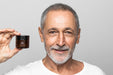 Free Close Up Man Holding Cream Container Psd
