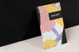 Free Colorful Paperboard Mockup Against The Black Wall Psd