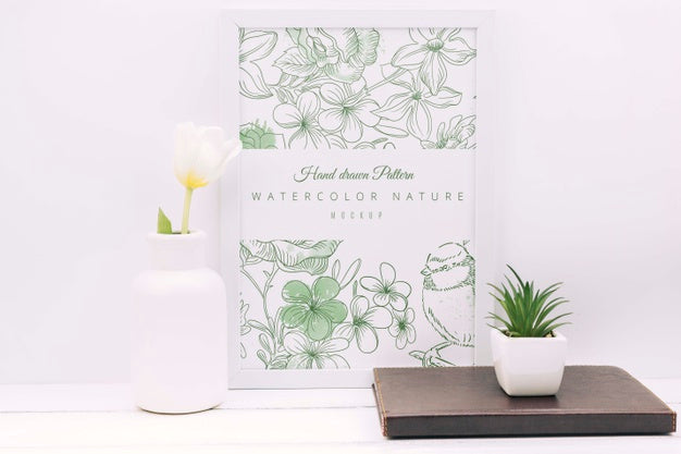 Free Desk Composition With Flower Decor And Frame Mockup Psd