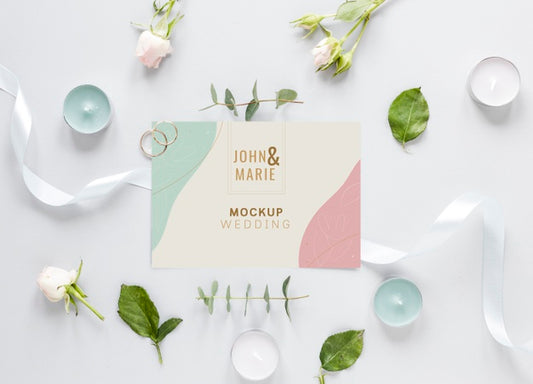Free Fat Lay Of Wedding Card With Candles And Flowers Psd