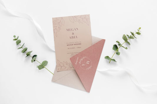 Free Fat Lay Of Wedding Card With Envelope And Plants Psd