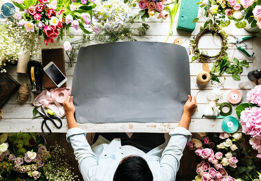 Free Florist Showing Empty Design Space Paper On Wooden Table With Fresh Flowers Decorate