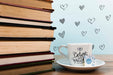 Free Front View Cup Of Coffee With Label And Pile Of Books Psd