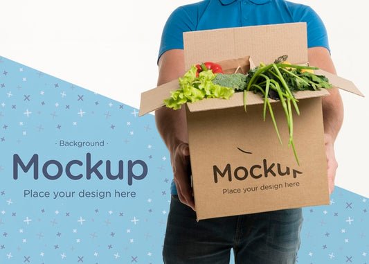 Free Front View Delivery Man Holding A Box With Different Vegetables Psd