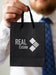 Free Front View Man Holding A Paper Bag Mock-Up Psd