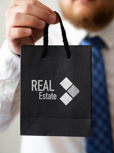 Free Front View Man Holding A Paper Bag Mock-Up Psd