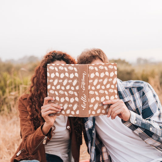 Free Front View Of Couple Looking In A Book Psd