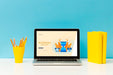 Free Front View Of Desk With Laptop And Pencils Psd