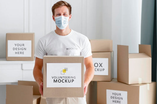 Free Front View Of Male Volunteer With Medical Mask Holding Food Donation Box Psd