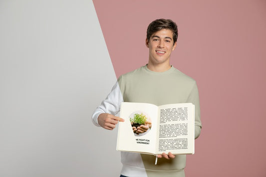 Free Front View Of Man Pointing At Book He'S Holding Psd