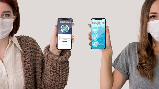 Free Front View Of Two Women With Masks Holding Smartphones Psd