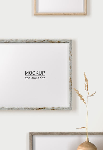 Free Front View Of Wall Decoration With Frames And Vase Psd