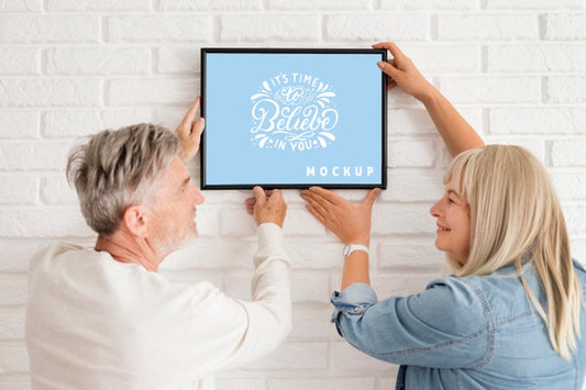 Free Front View Of Woman Holding A Frame Mock-Up Psd