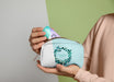 Free Front View Of Woman Holding Make-Up Pouch Psd