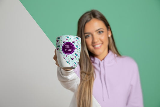 Free Front View Of Woman In Hoodie Holding Up Mug Psd