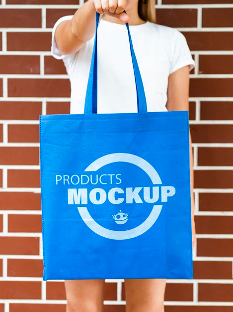 Free Front View Woman Holding A Plain Blue Bag Psd