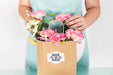 Free Gardening Concept With Woman Preparing Bag With Flowers Psd
