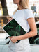Free Hands Holding A Nature Magazine Next To A Car Psd