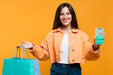 Free Happy Woman Holding Shopping Bags And A Phone Mock-Up Psd
