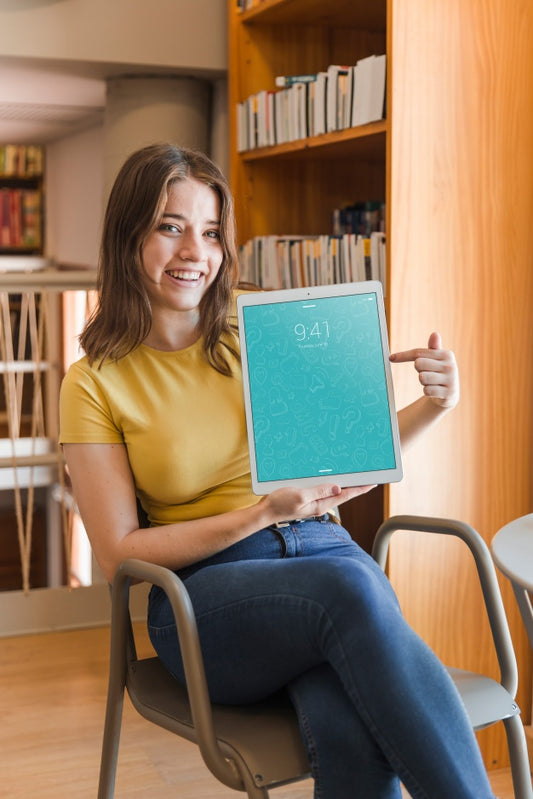 Free Happy Woman Holding Tablet Mockup In Library Psd