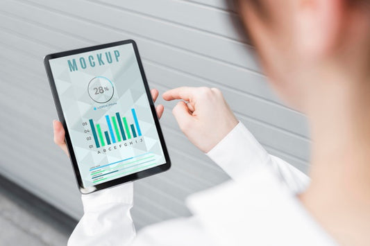 Free High Angle Of Woman Holding A Tablet Mock-Up Psd