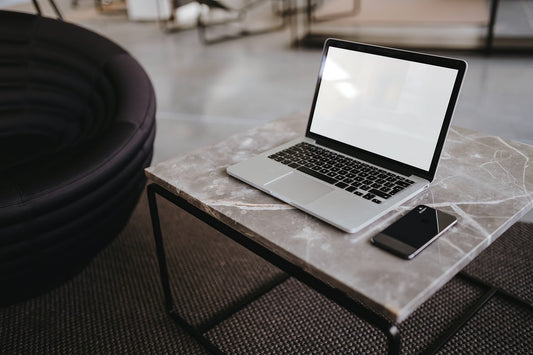 Free Laptop And A Phone On A Marble Table