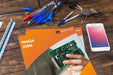 Free Magazine And Smartphone Mockup On Wooden Table With Pens And Rulers Psd