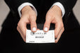 Free Man In Suit Holding A Business Card Psd