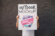Free Man Presenting Poster Mockup In Front Of Wall Psd