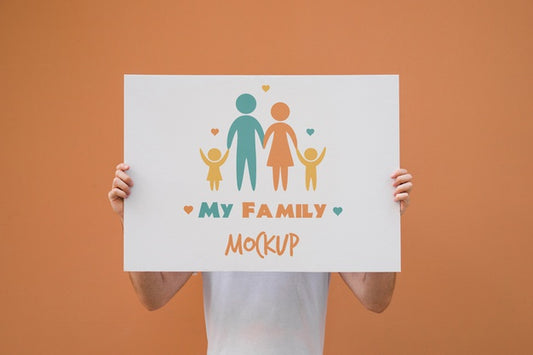 Free Man Presenting Poster Mockup On Orange Background Psd