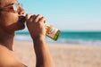 Free Man With Beer Bottle Mockup At The Beach Psd