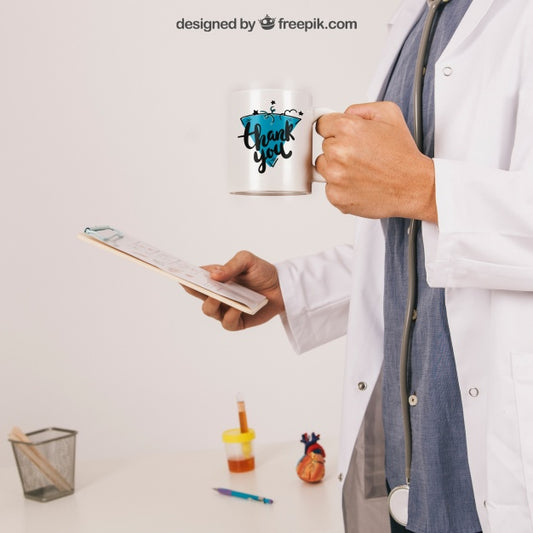 Free Mock Up With Doctor Holding Coffee Mug And Clipboard Psd