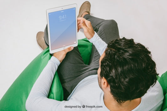 Free Mock Up With Man Relaxing With Tablet Psd