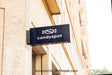 Free Mockup Of Black Shop Sign On Wall Psd