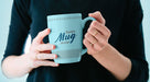 Free Mug In Female Hand Mockup Psd