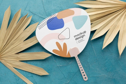 Free Paper Mock-Up Hand Fan With Dry Leaves Psd