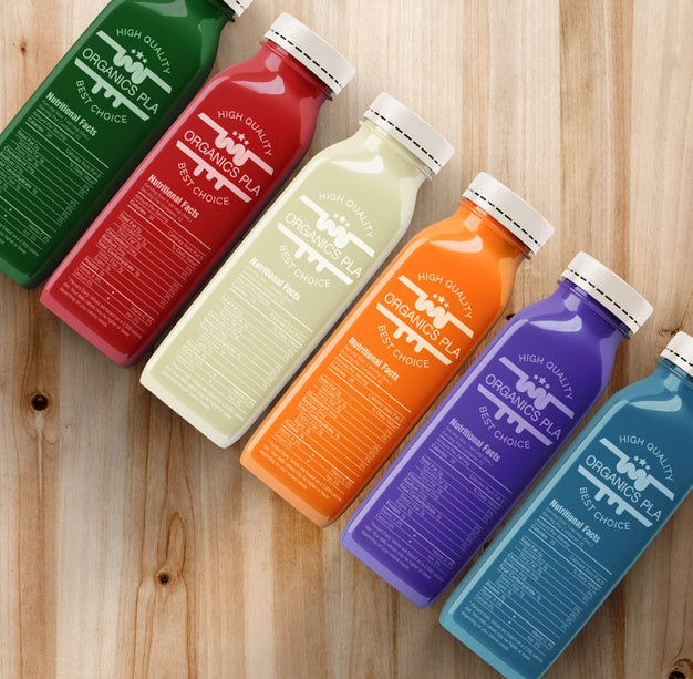 Free Plastic Bottles With Different Fruit Or Vegetable Juices Top View Psd