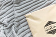 Free Plastic Package Mockup On A Bed Psd