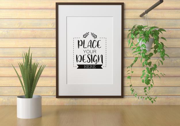 Free Poster Frame Mockup On The Wall With Plant Psd