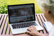 Free Senior Woman Using A Laptop On Vacation Psd